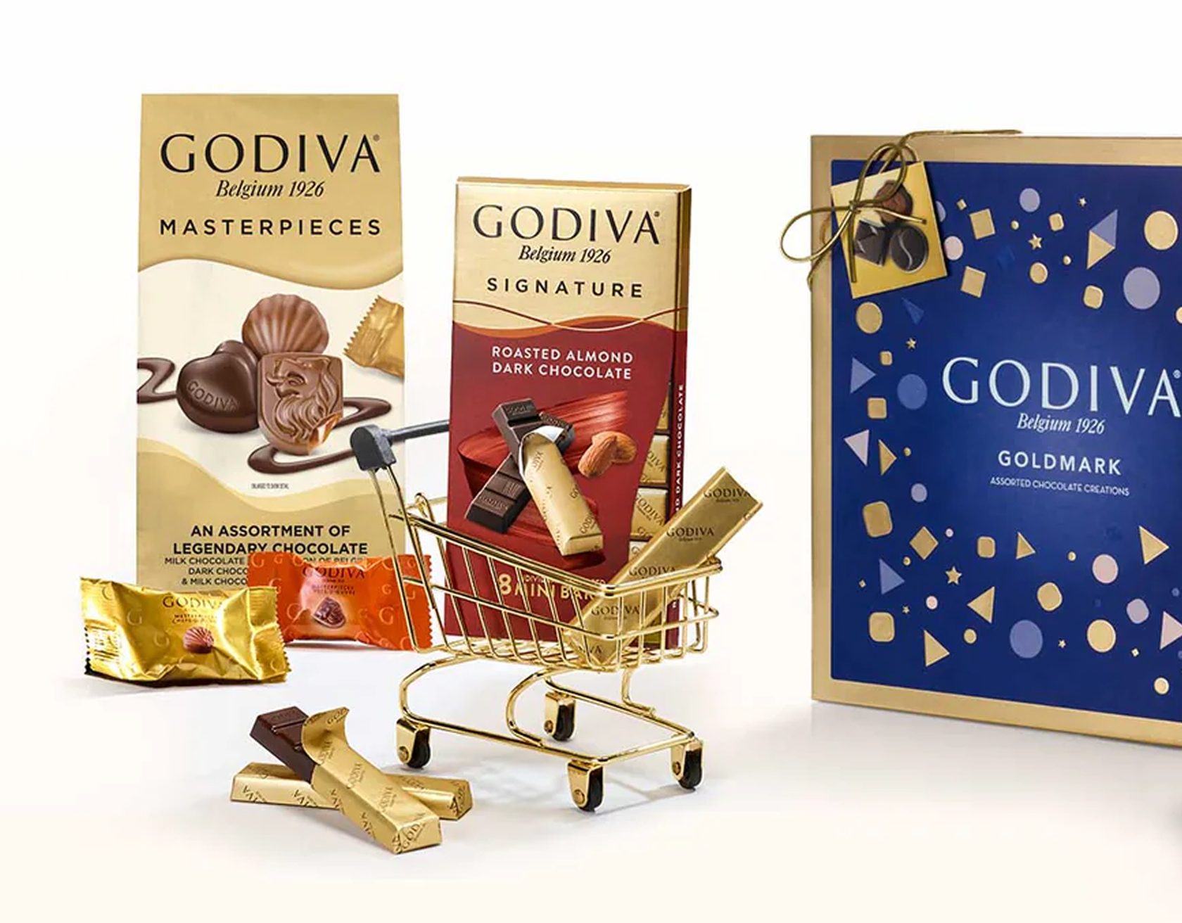 Godiva chocolate products with a small shopping cart and mini chocolate bars on a white background.